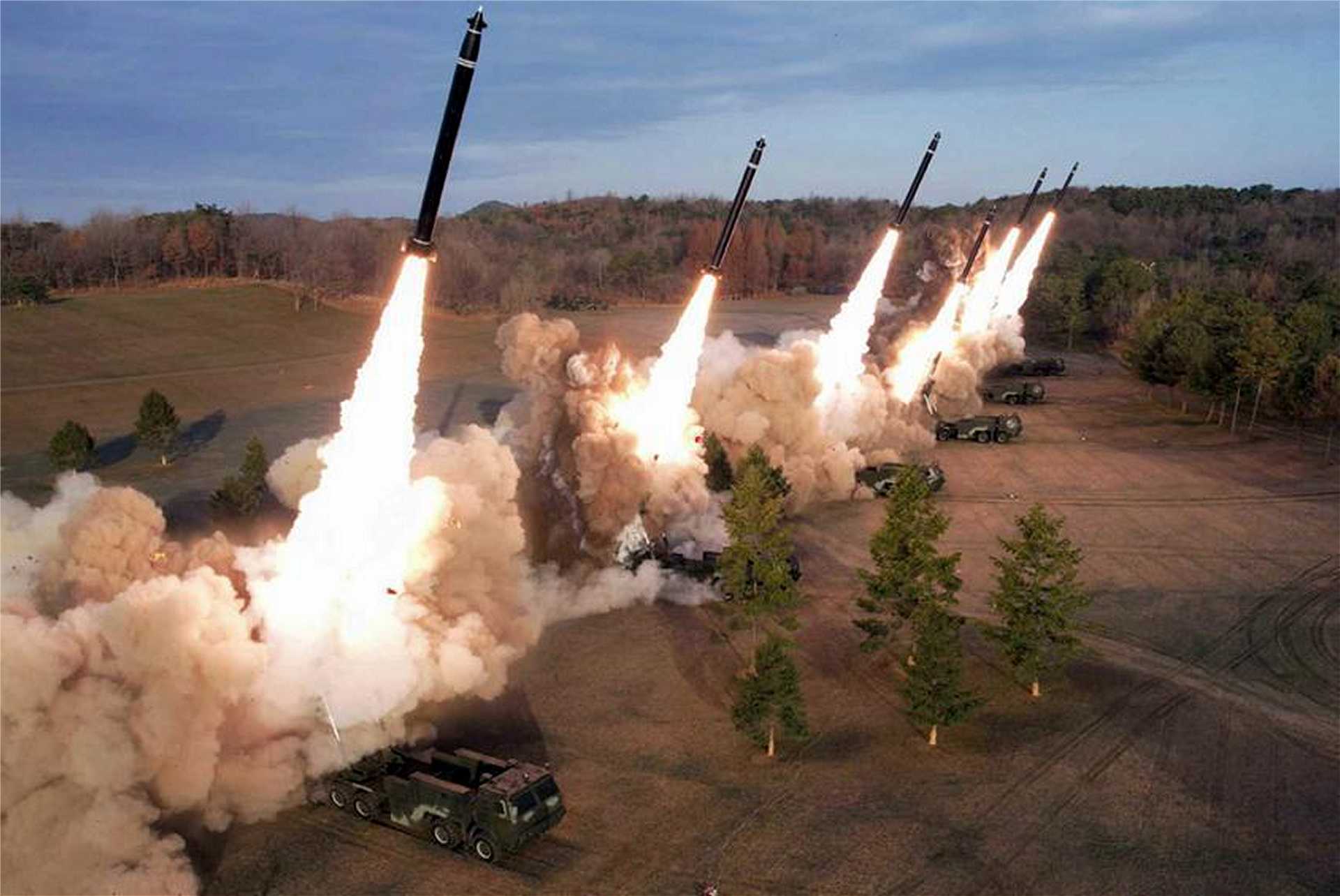 North Korea’s 600 mm multiple rocket launcher system fires a coordinated salvo during a previous military exercise. The September 12, 2026 launches may have involved both Hwasong-11-series short-range ballistic missiles and 600 mm guided rockets, highlighting the potential missile-saturation challenge facing U.S., South Korean and Japanese air and missile defenses.