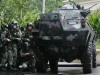Philippines Army V-150 wheeled armoured vehicle picture . Special Forces assault the Peninsula Hotel in Makati City, metro Manila against Renegade Philippine soldiers, November 29, 2007. Renegade Philippine soldiers said on Thursday they would leave a Manila hotel after elite forces battered down the door and fired tear gas into the lobby. 