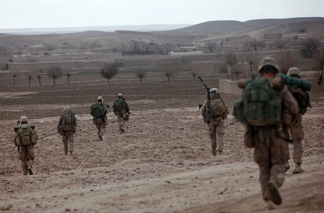 Marines with Fox Company, 2nd Battalion, 4th Marine Regiment, move from Patrol Base 7171 to another position to begin their participation in the second phase of Operation Double Check, a battalion-level offensive to rid areas of southern Musa Qal’eh district of insurgents. 