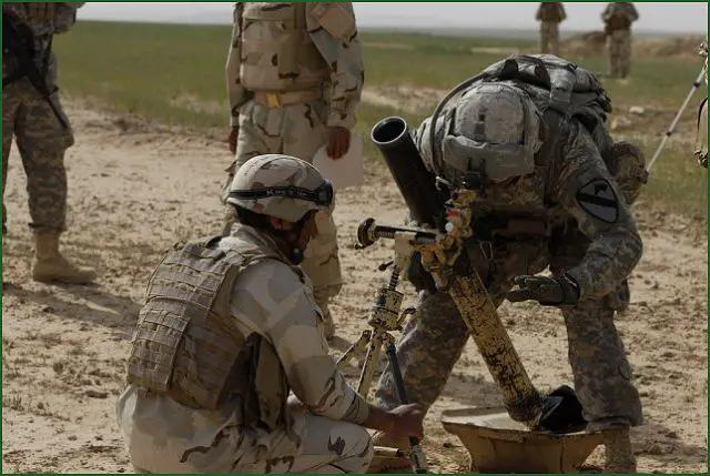 Staff Sgt. Ricardo Mendoza, noncommissioned officer in charge for a 81 mm mortar system assigned to Headquarters and Headquarters Troop, 1st Squadron, 9th Cavalry Regiment, 4th Advise and Assist Brigade, 1st Cavalry Division, helps an Iraqi soldier (Image U.S. Army Copyright)