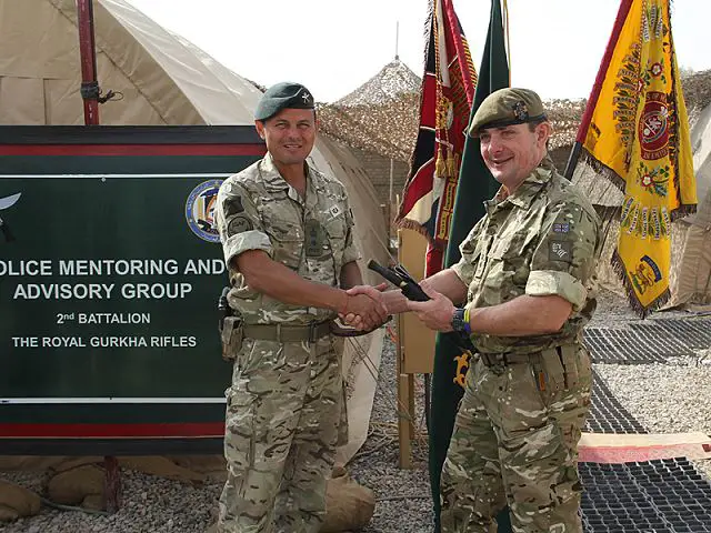 Lieutenant Colonel James Coote (right), Commanding Officer of 1st Battalion The Princess of Wales's Royal Regiment, exchanges gifts with Lieutenant Colonel Fraser Rea, Commanding Officer of 2nd Battalion The Royal Gurkha Rifles, during the handover of the Police Mentoring and Advisory Group in Lashkar Gah, Helmand province