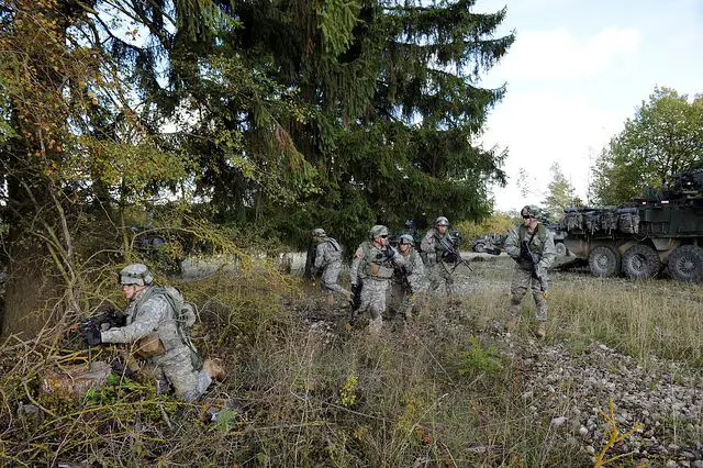 U.S. Army Soldiers from 2nd Squadron, 2nd Cavalry Regiment move to secure an area during an assault on Duzdag village here Oct. 13. The mission is part of U.S. Army Europe's exercise Saber Junction trains U.S. personnel and more than 1800 multinational partners from 18 different nations ensuring multinational interoperability and an agile, ready coalition force.