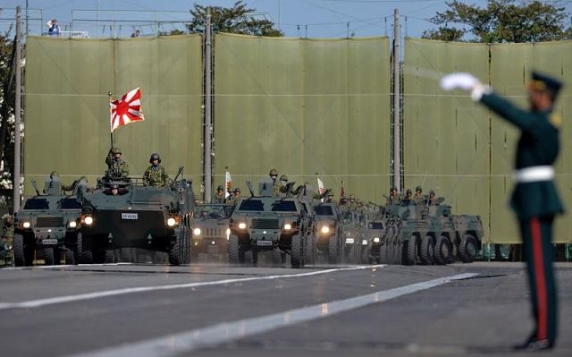 Japan on Tuesday, December 17, 2013, approved a plan to increase defense spending by 5 percent over the next five years to purchase its first surveillance drones, more jet fighters, naval destroyers, beach-assault vehicles and troop-carrying aircraft in the face of China's military expansion.