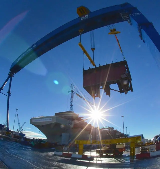 Workers at the Aircraft Carrier Alliance celebrated the creation of the UK’s biggest ever aircraft carrier as the final piece of the hull’s main structure was lowered into place yesterday (November 10). Under the watchful eye of shipyard workers the Goliath crane gently manoeuvred the very front part of the aircraft ramp or ‘ski-jump’ of HMS Queen Elizabeth into place.