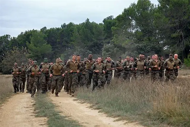U.S. Marines with Special-Purpose Marine Air-Ground Task Force Crisis Response and Legionnaires with the 2nd Foreign Infantry Regiment of France's 6th Light Armored Brigade take part in a 7K obstacle course after conducting a heliborne raid Oct. 31, 2013, at Camp des Garrigues, France.