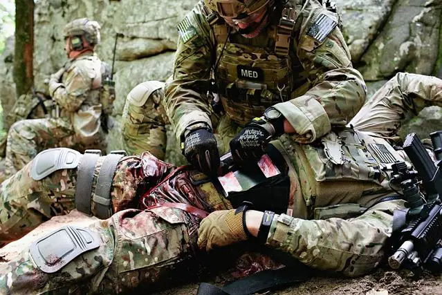 In a demonstration exercise, a medic shows how the Abdominal Aortic Tourniquet would work in combat to help stop the bleeding from a pelvis injury.