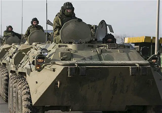 A Russian warship unloaded trucks, troops and at least one armored personnel carrier at a bay near Sevastopol in Crimea on Friday, march 14, 2014, morning, as Moscow continued to build up its forces on the Ukrainian peninsula.