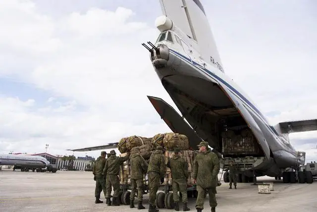 Russian air force personnel prepare to load humanitarian cargo on board a Syrian plane at Hemeimeem air base in Syria, Wednesday, Jan. 20, 2016. 