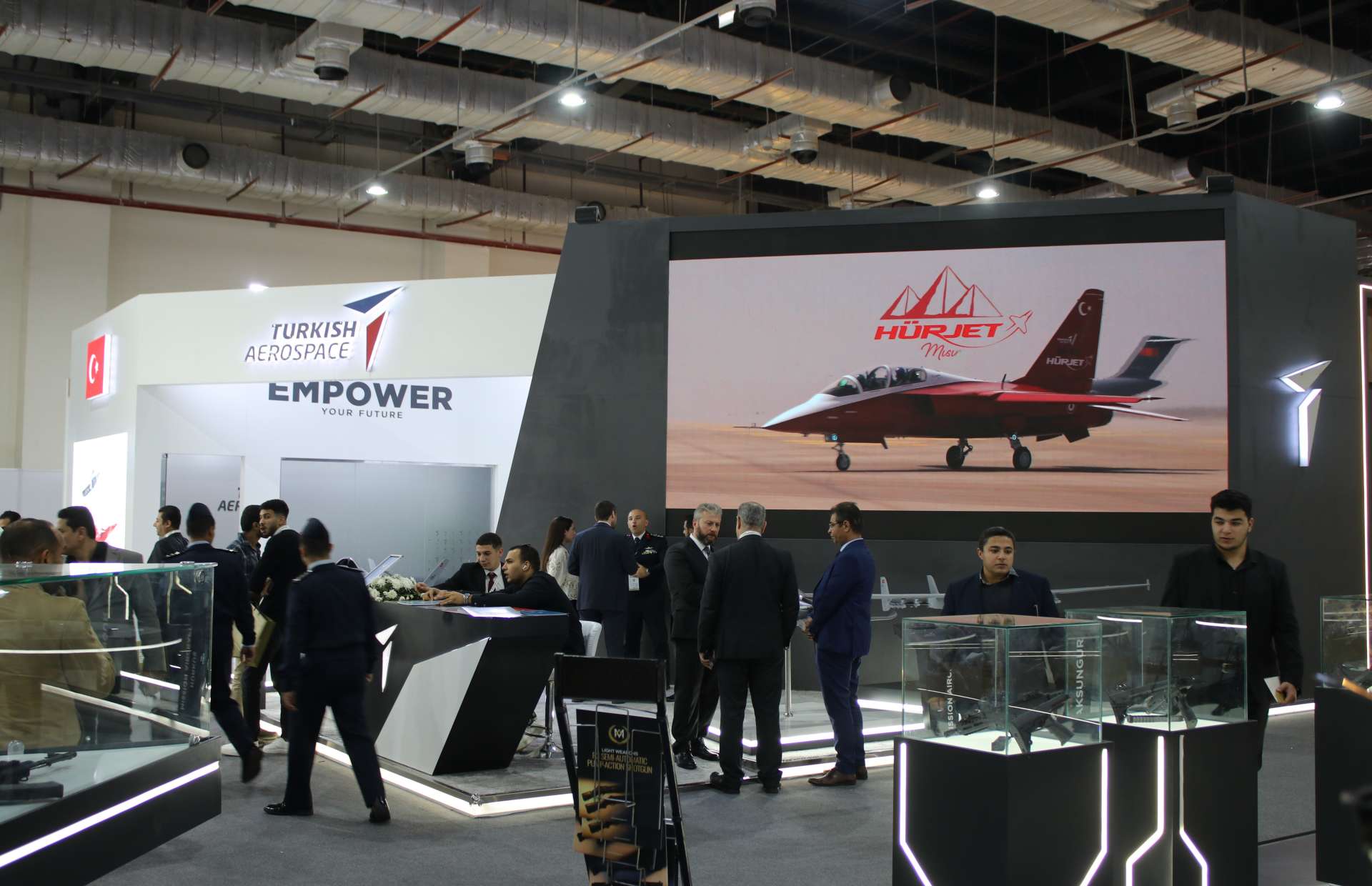 Turkish Aerospace showcases its full airpower portfolio at EDEX 2025, highlighting the KAAN fifth-generation fighter, HÜRJET trainer, ANKA and ANKA III unmanned systems, T129 ATAK helicopter, and Şimşek target drone as the company strengthens its export presence across the Middle East and Africa (Picture source: Army Recognition Group).
