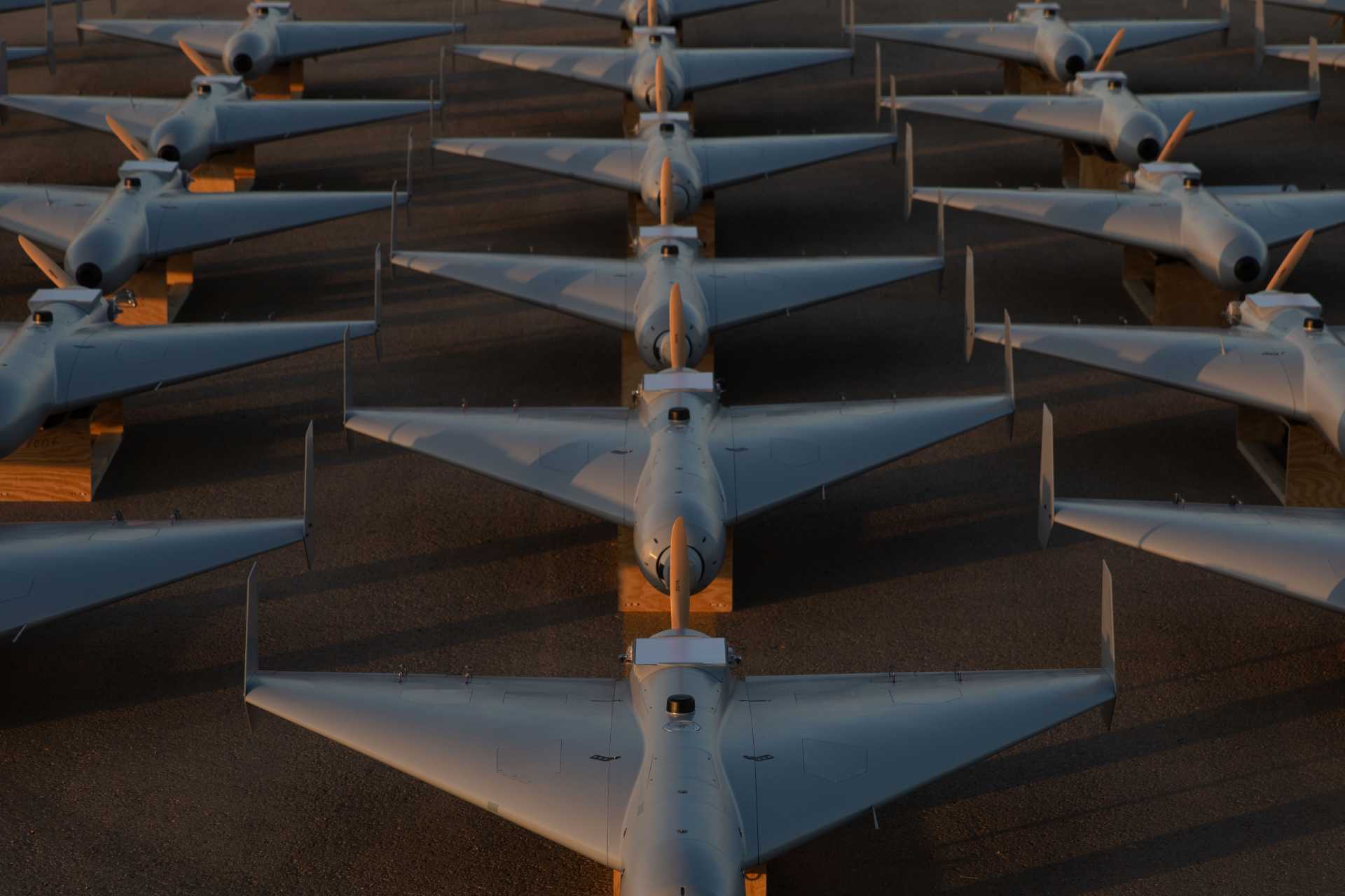 Low-cost unmanned combat attack drones operated by U.S. Central Command sit ready on the tarmac at an undisclosed base within CENTCOM’s area of operations, November 23, 2025. These one-way strike drones are part of a newly deployed squadron in the Middle East, aimed at enhancing regional deterrence and rapid-response capabilities.