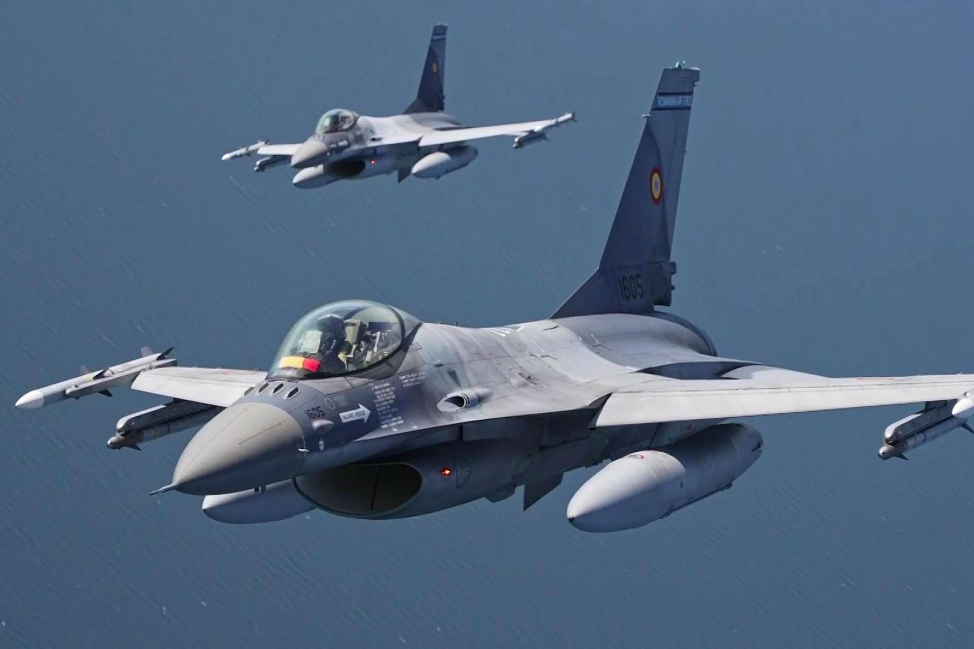 Two Romanian Air Force F-16s fly above the Baltic Sea, modernized to NATO standards with advanced radar, avionics, and precision weapons for air policing and defense (Picture Source: NATO's Allied Air Command)