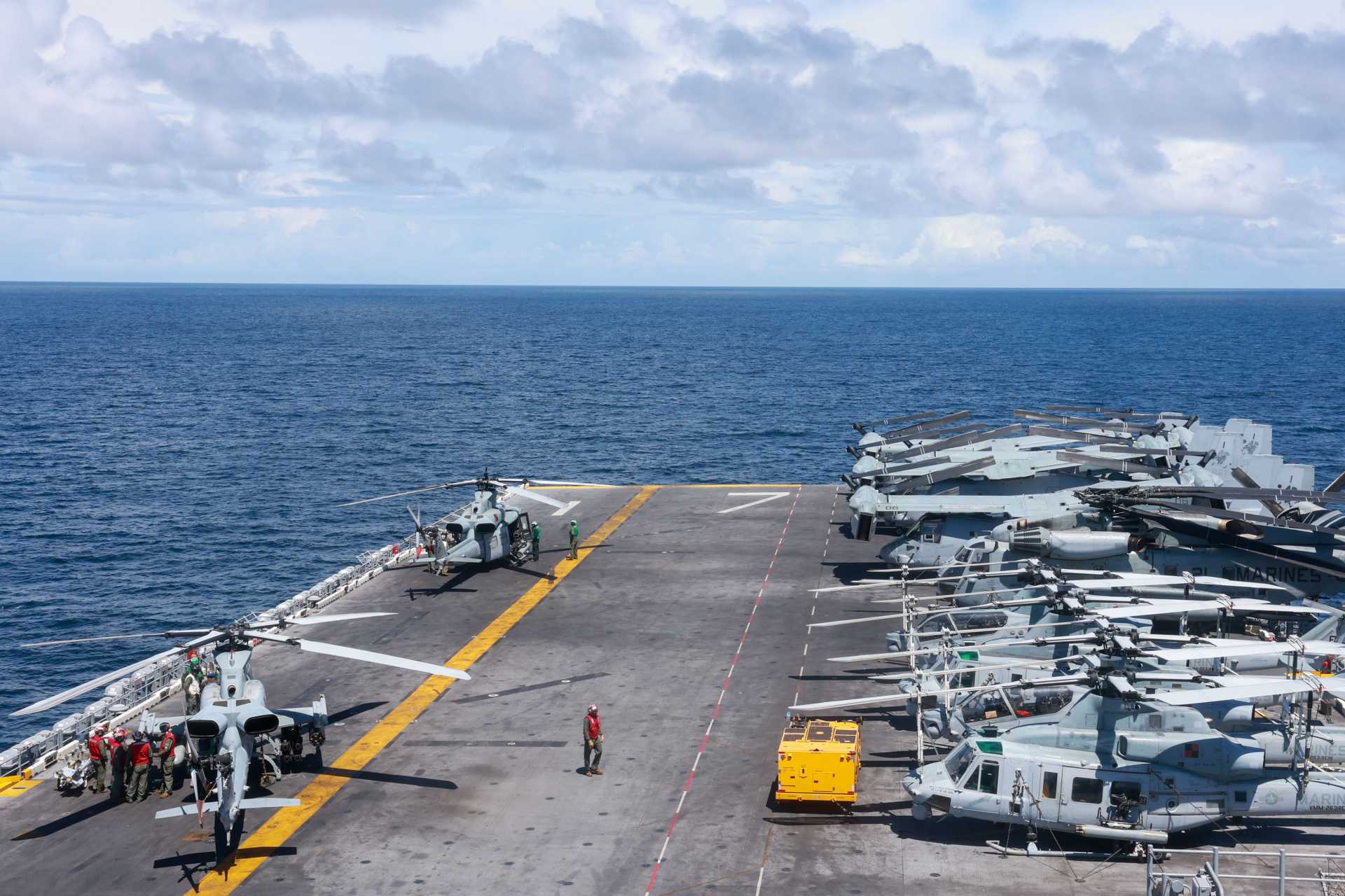 U.S. Marines, assigned to Marine Medium Tiltrotor Squadron (VMM) 263 (Reinforced), prepare an UH-1Y Huey and an AH-1Z Cobra for take-off on the flight deck of the Wasp-class amphibious assault ship USS Iwo Jima (LHD 7) deployed in the Caribbean Sea in support of the U.S. Southern Command mission.