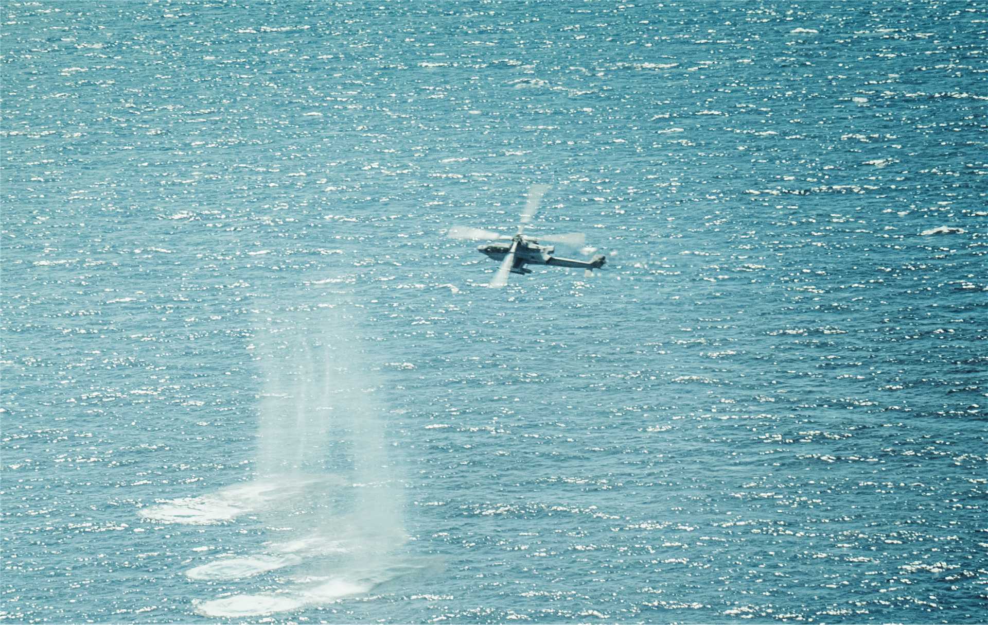 A U.S. Marine Corps AH-1Z Viper attack helicopter assigned to Marine Medium Tiltrotor Squadron 263 (Reinforced), 22nd Marine Expeditionary Unit (Special Operations Capable), conducts precision strikes on maritime targets during a live fire exercise in the Caribbean Sea, September 22, 2025.