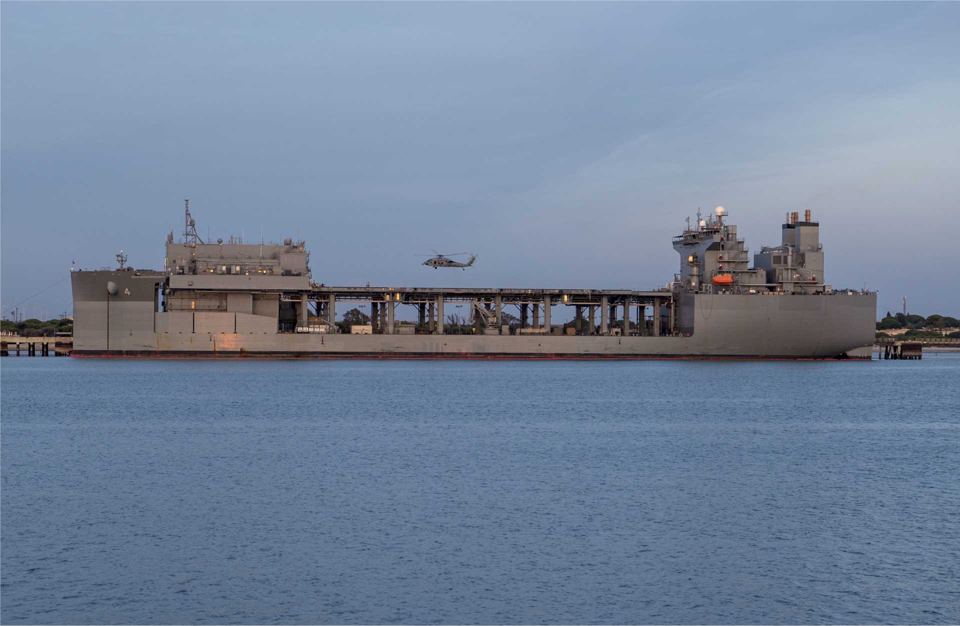 An Expeditionary Sea Base is a 90,000-ton mobile offshore support ship that acts as a floating military hub, providing aviation facilities, mission spaces, personnel accommodation and logistics support for U.S. Navy, Marine Corps, special operations and joint forces without relying on fixed ports or airfields.