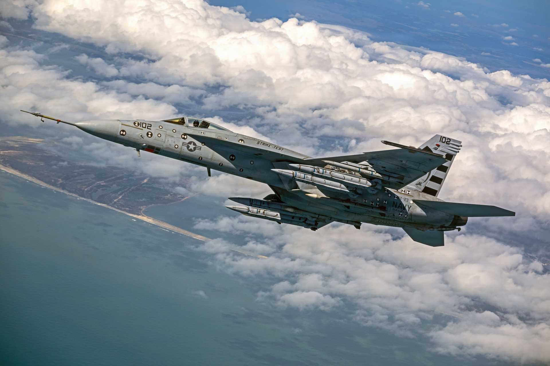 Four AIM-424 Long Range Air-to-Air Missiles are loaded onto a U.S. Navy F/A-18E Super Hornet for testing. The next-generation missile is designed to extend the engagement range, lethality, and defensive reach of Navy and Marine Corps aviation against advanced airborne threats.