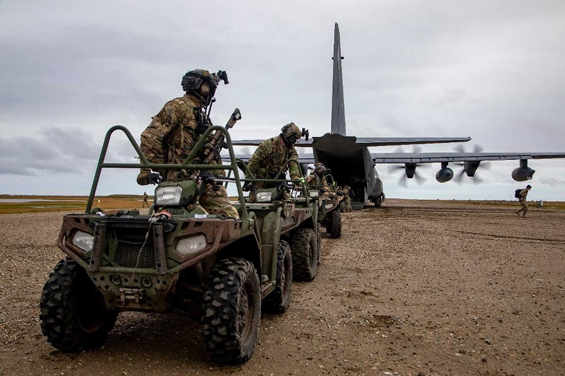 U.S. Army Green Berets from the 10th Special Forces Group load all-terrain vehicles onto a U.S. Air Force MC-130J Commando II during Operation POLAR DAGGER in Wales, Alaska, on August 17, 2024, demonstrating rapid Arctic infiltration and mobility near the Bering Strait.