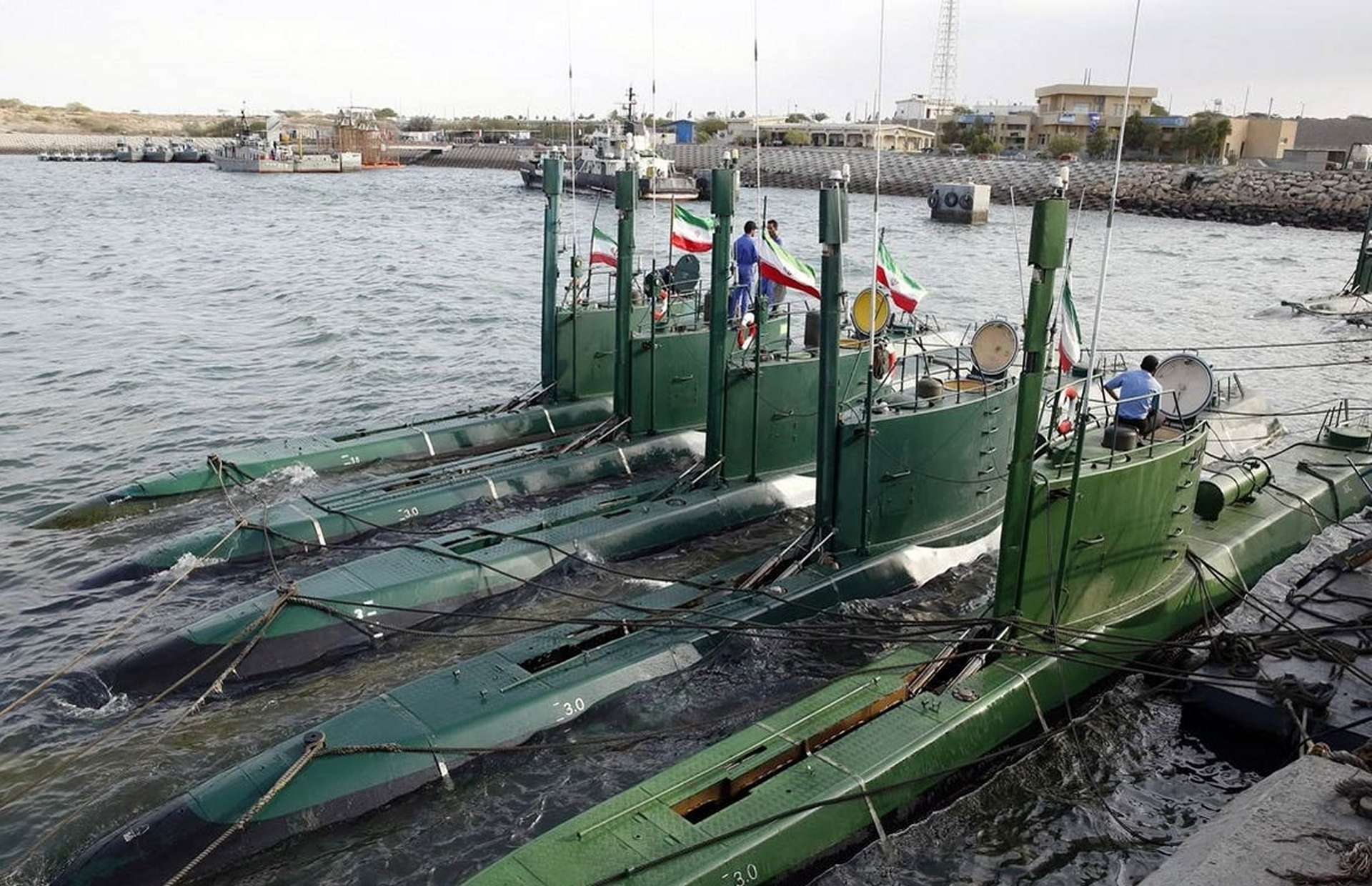 Iran’s Ghadir-class midget submarines, tiny diesel-electric boats built for the Persian Gulf’s shallow, noisy waters, can ambush with torpedoes, mines, and possibly sub-launched anti-ship missiles, forcing U.S. carrier strike groups to slow down, widen standoff distances, and spend heavily on anti-submarine warfare just to operate safely near Iran (Picture source: Irna).