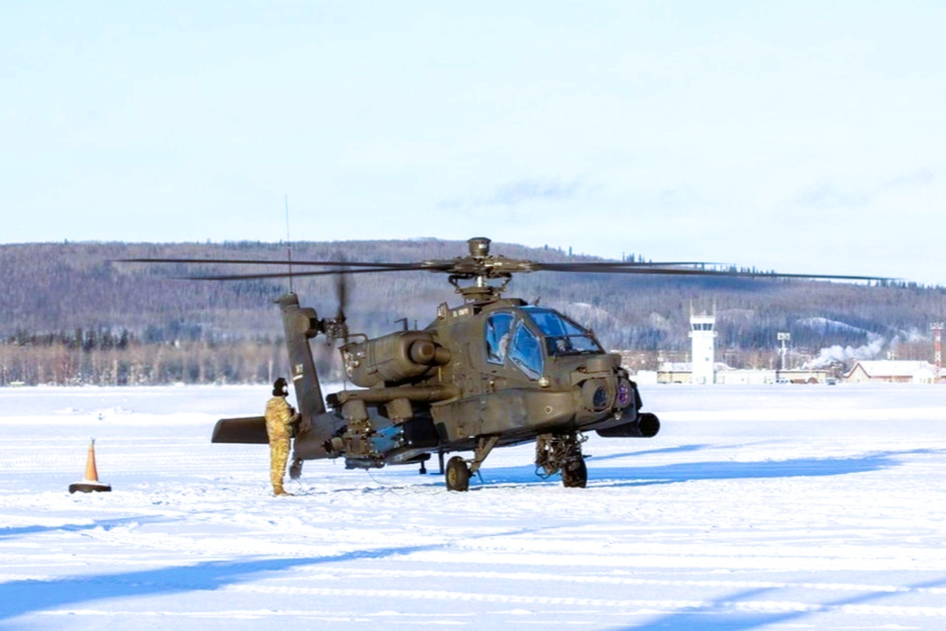 U.S. Army soldiers launched AH-64E Apache helicopters from snow-covered pads in Alaska during JPMRC 26-02, showcasing expanded Arctic combat aviation capabilities under extreme cold conditions (Picture Source: DVIDS)