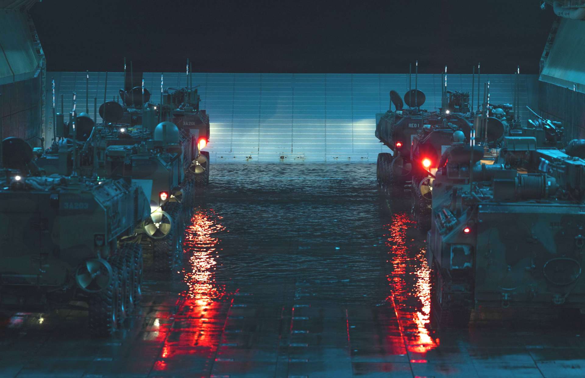 USMC Amphibious Combat Vehicle-Personnel (ACV-P) 8x8 is an armored, fully amphibious troop carrier launching from assault ships. It carries 3 crew + 13 Marines, swims in open-water surf, then continues high-speed cross-country. Remote weapon station (.50 cal or 40 mm Mk19) provides protected suppressive fire for ship-to-shore assault and inland security (Picture source: U.S. Marines).