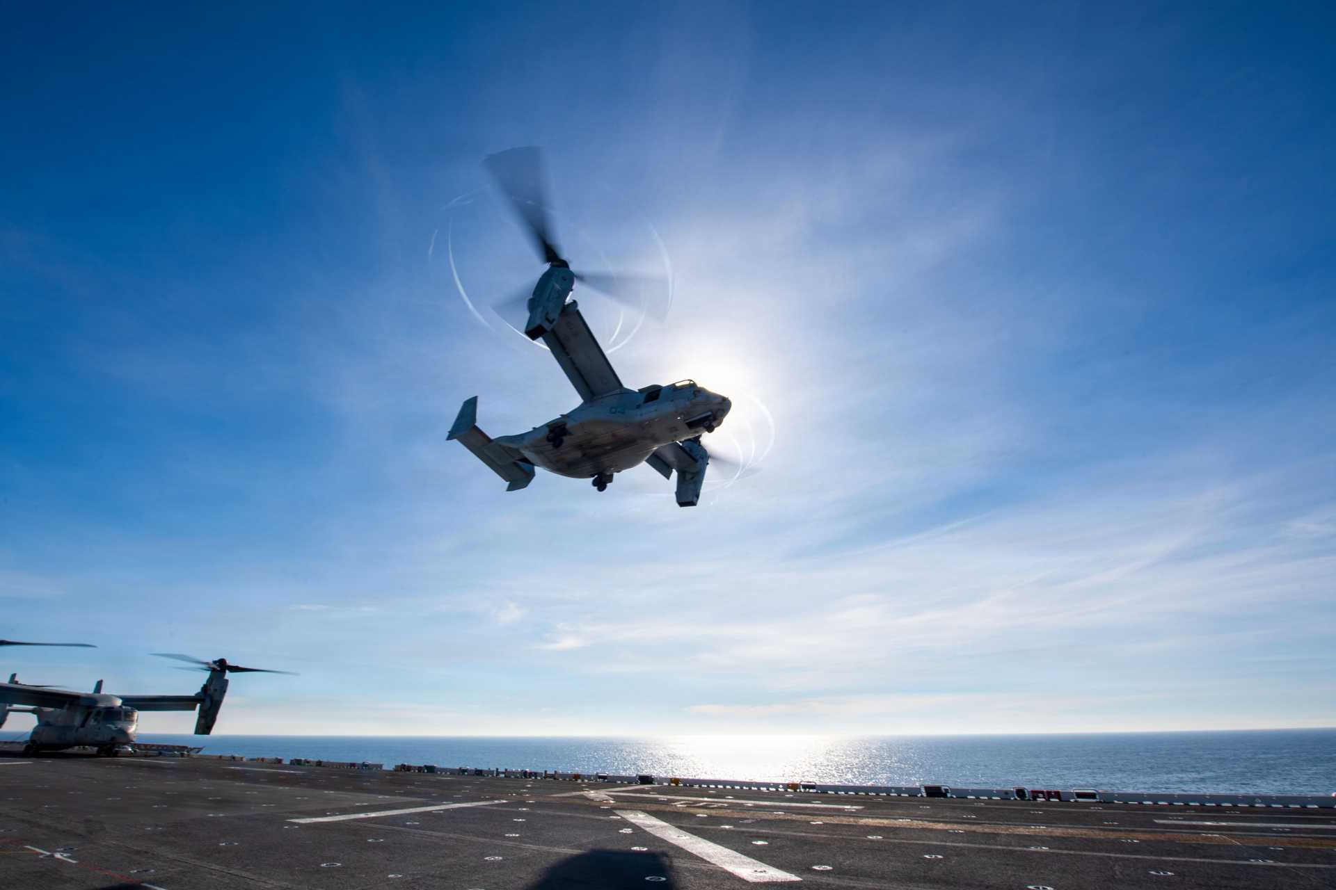 An MV-22B Osprey assigned to VMM-163 lifts off from the flight deck of USS Boxer during integrated ARG-MEU training operations in the Indo-Pacific, demonstrating extended-range sea-based assault capability.