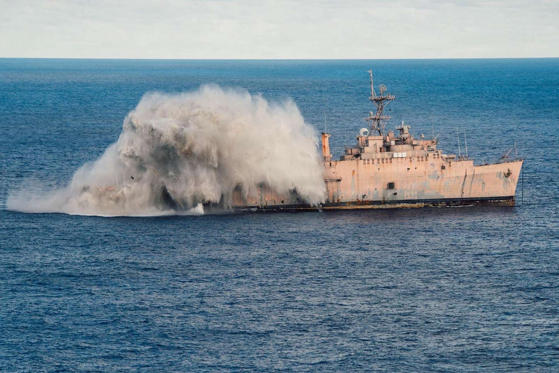 A Japan Maritime Self-Defense Force submarine fires a heavyweight torpedo at the decommissioned USS Juneau (LPD-10) during Exercise Valiant Shield 2026 in the Philippine Sea, testing allied anti-ship strike coordination and real-world weapon effects against a former U.S. amphibious warship (Picture source: U.S. Navy).