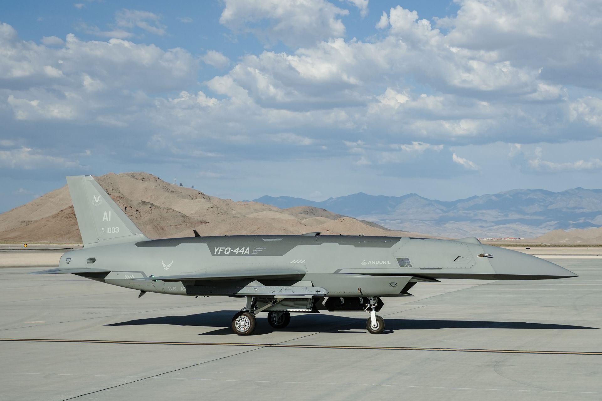 A U.S. Air Force YFQ-44A Fury assigned to the Collaborative Combat Aircraft Experimental Operations Unit undergoes weapon loading procedures on the flight line at Creech Air Force Base, Nevada, on July 21, 2026. (Picture source: US DoD)