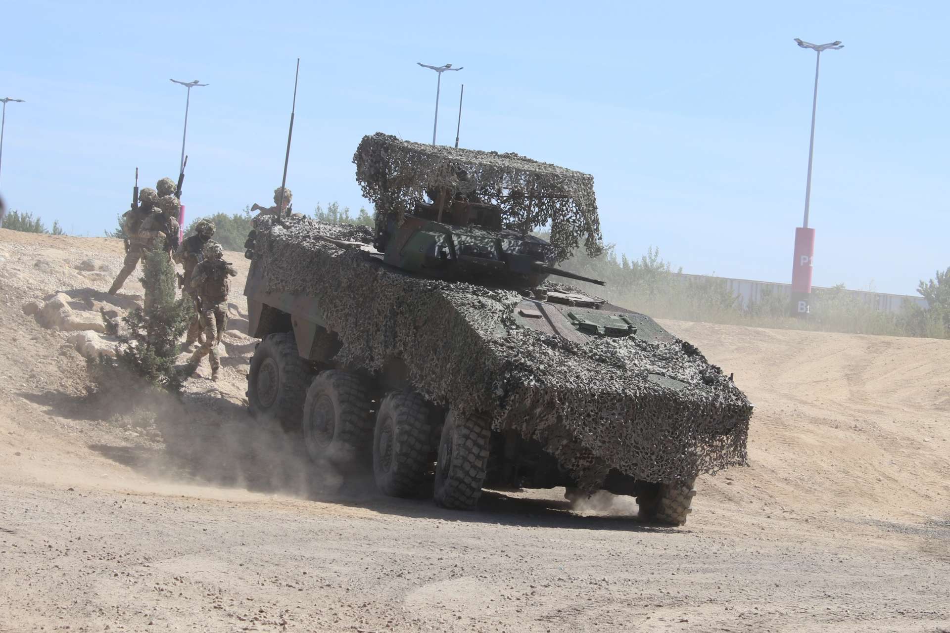 The French Army showcased a VBCI 8x8 infantry fighting vehicle equipped with extensive camouflage and a turret-mounted overhead protective structure at Eurosatory 2026, highlighting adaptations designed to improve survivability against drones, aerial surveillance, and top-attack threats (Picture Source: Army Recognition Group)