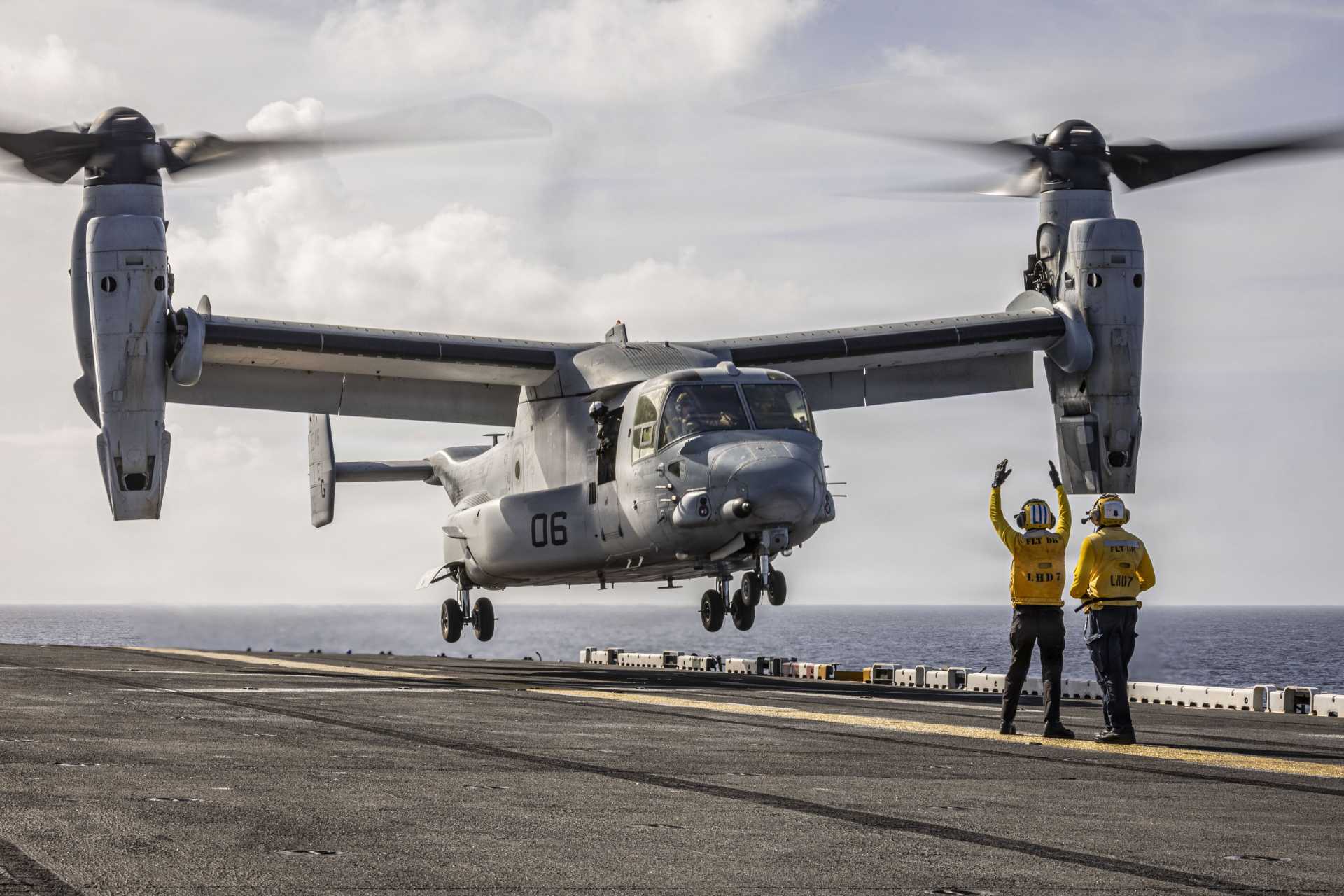 A U.S. Sailor assigned to the Iwo Jima Amphibious Ready Group directs an MV-22B Osprey as it prepares for takeoff from the flight deck of the Wasp-class amphibious assault ship USS Iwo Jima (LHD 7) during operations in the Caribbean Sea.