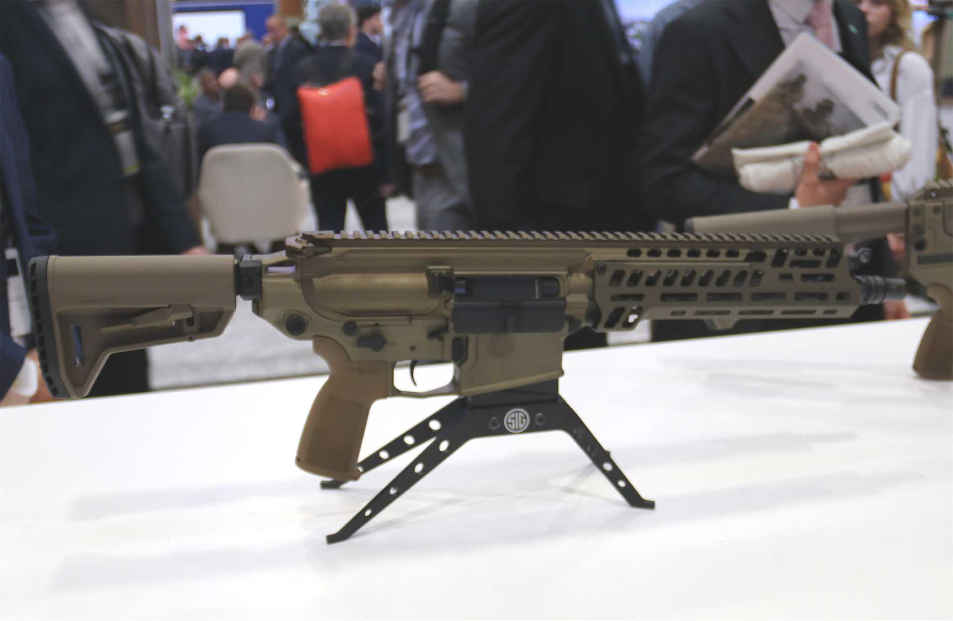 SIG Sauer's new XM8 6.8 mm carbine displayed at AUSA 2026 in Washington, D.C. Developed from the U.S. Army's M7 rifle, the XM8 is approximately 12% lighter and 3.5 inches shorter, improving soldier mobility and weapon handling in close combat while retaining the M7's 6.8 mm ammunition and advanced fire-control compatibility. (Picture source Army Recognition Group)