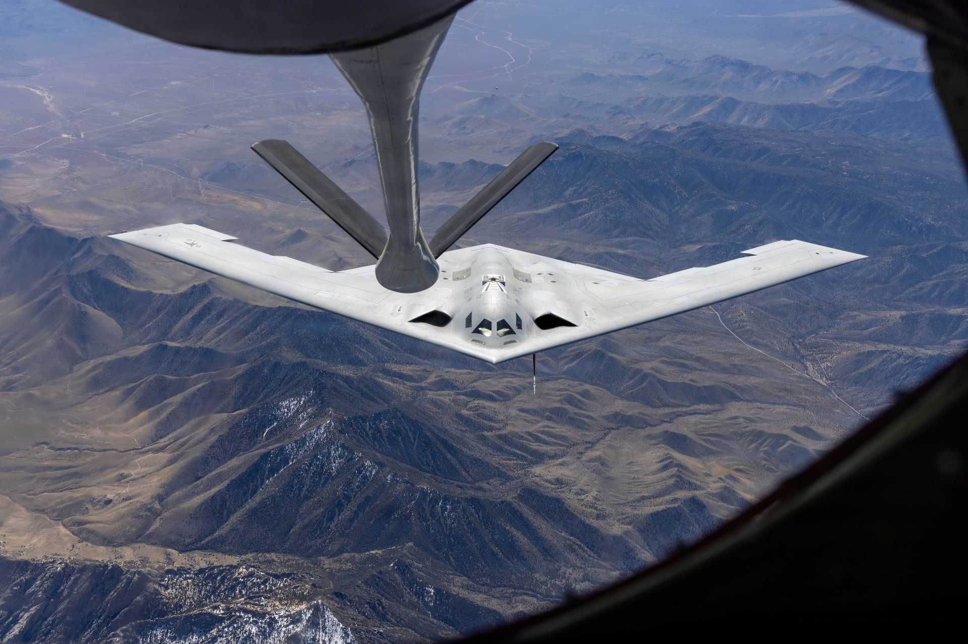 A B-21 Raider joins a KC-135 Stratotanker during flight testing. The U.S. Air Force has begun construction of a new B-21 final assembly line at Plant 42 in Palmdale, California, as part of an expansion designed to increase annual Raider production capacity by 25 percent.