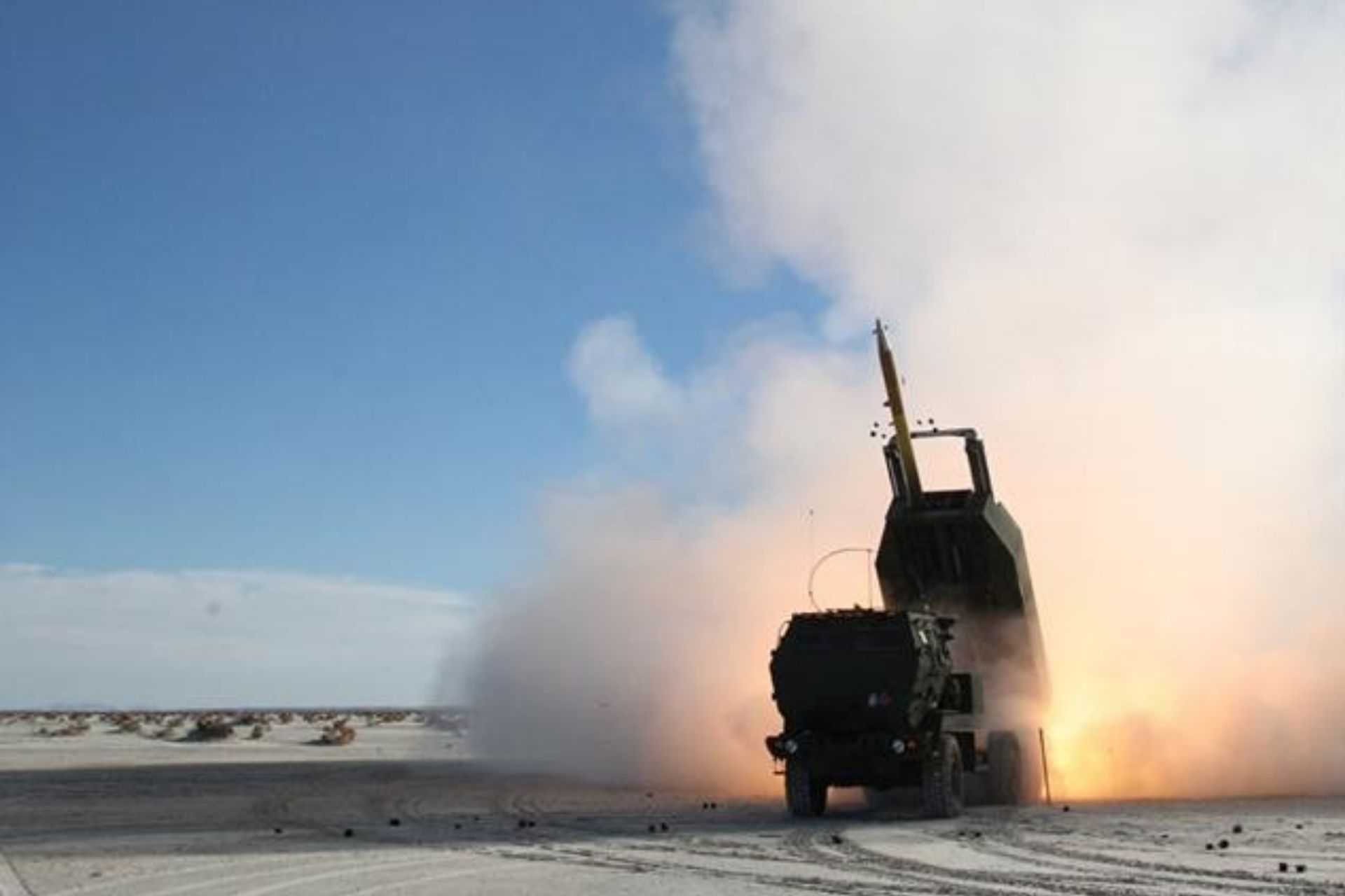 U.S. Marines fire an M31 GMLRS precision-guided rocket from an M142 HIMARS during a live-fire exercise at White Sands Missile Range, New Mexico, on December 4, 2015. The same rocket family was used in a 2026 U.S. Army test demonstrating the ability to redirect a munition in flight to destroy a moving target. (Picture source: US DoD)