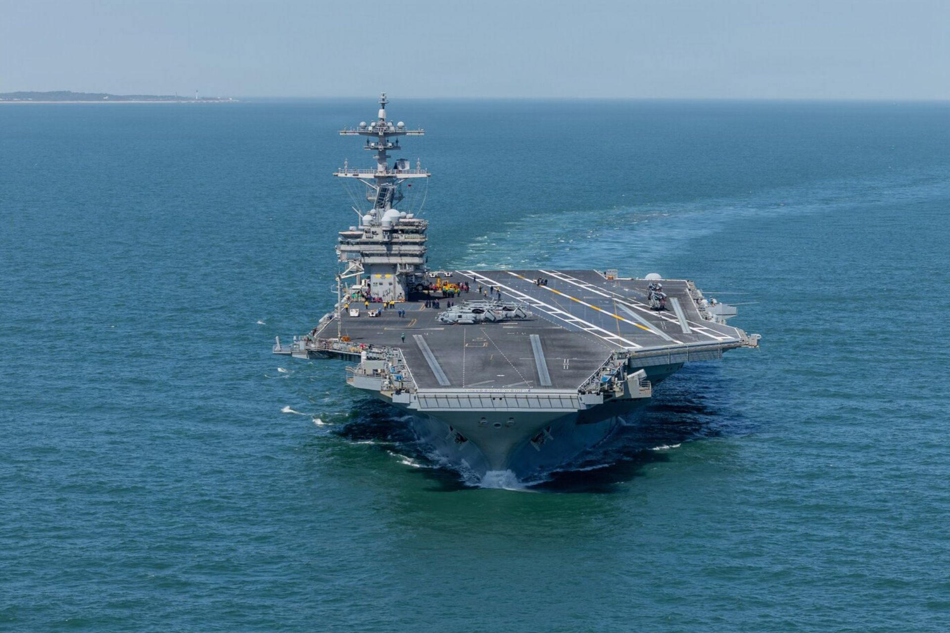 The U.S. Navy's nuclear-powered aircraft carrier USS George H.W. Bush (CVN-77), pictured departing Norfolk in March 2026, has reportedly returned to the Arabian Sea, joining USS George Washington to expand American carrier-based air operations near Iran. (Picture source: U.S. Navy)