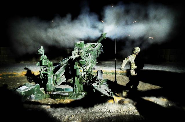 A United States gun crew fires illumination rounds at Forward Operating Base Hadrian. The 1st Section Bravo Battery 1-9 Field Artillery from Fort Stewart, Ga., have been conducting intensive training and fire missions to support operations in Uruzgan province, Afghanistan.