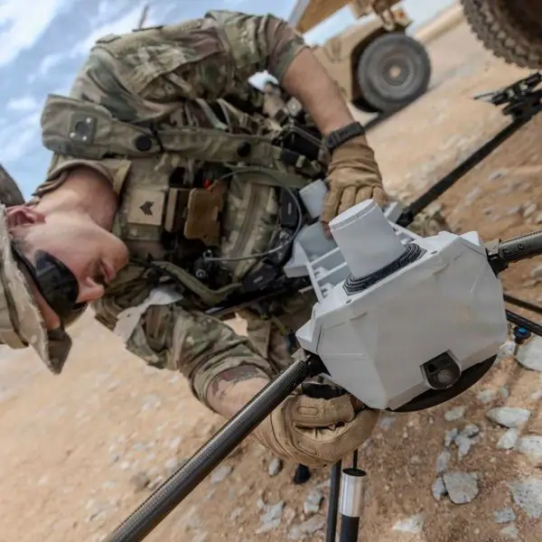 U.S. Army Sgt. Jonathan Simmons, assigned to the 4th Infantry Division, assembles a PDW C-100 drone equipped with the Picatinny Common Lethality Integration Kit during Project Convergence Capstone 6 at Fort Irwin, California, on July 20, 2026. The kit enables compatible drones to carry interchangeable lethal payloads, supporting more flexible strike capabilities for U.S. Army soldiers. (Picture source: U.S. Department of War/Defense)