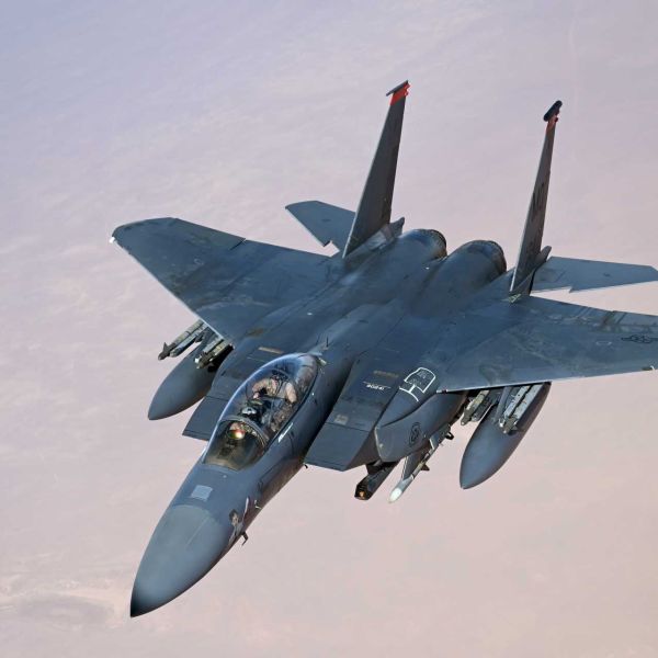 A U.S. Air Force F-15E Strike Eagle conducts a combat air patrol over the U.S. Central Command area of responsibility. The aircraft supports regional deterrence and air-defense missions and has taken on an expanded counter-drone role, including the use of APKWS II guided rockets against unmanned aerial threats.