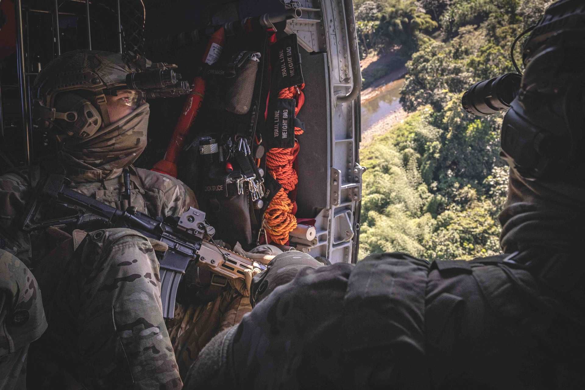 U.S. Special Operations Forces prepare for a maritime insertion from a U.S. Coast Guard HH-60 Jayhawk helicopter during a joint raid rehearsal over the Caribbean Sea in support of Operation SOUTHERN SPEAR.
