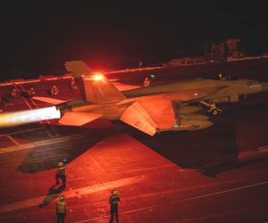 An F/A-18 Super Hornet prepares to launch from the flight deck of USS George Washington (CVN 73) while the aircraft carrier operates in Middle Eastern waters amid sustained U.S. naval activity linked to enforcement of the blockade against Iran.