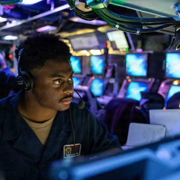 A U.S. Navy Fire Controlman monitors the Aegis Weapon System aboard the Arleigh Burke-class guided-missile destroyer USS Mustin (DDG 89) during a combat systems training drill in the Indian Ocean on June 25, 2026.