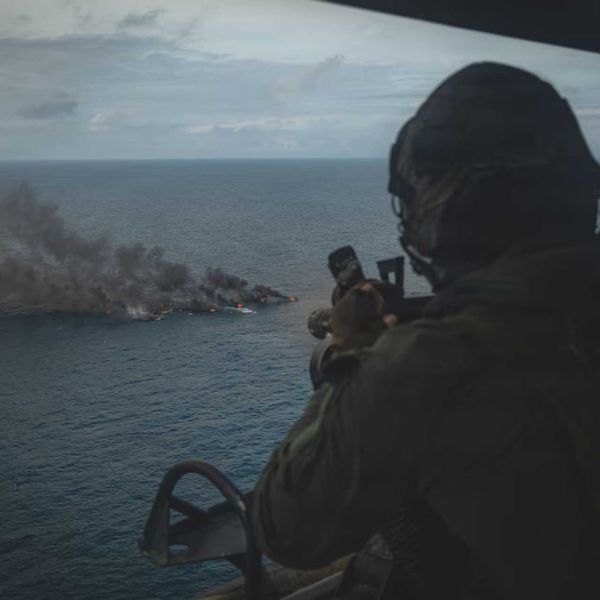 A U.S. Marine Corps UH-1Y Venom crew chief assigned to Marine Medium Tiltrotor Squadron (VMM) 365 (Reinforced), Littoral Combat Force-24, fires an M134 Minigun during a Maritime Interdiction Operation in the Pacific Ocean on September 15, 2026.