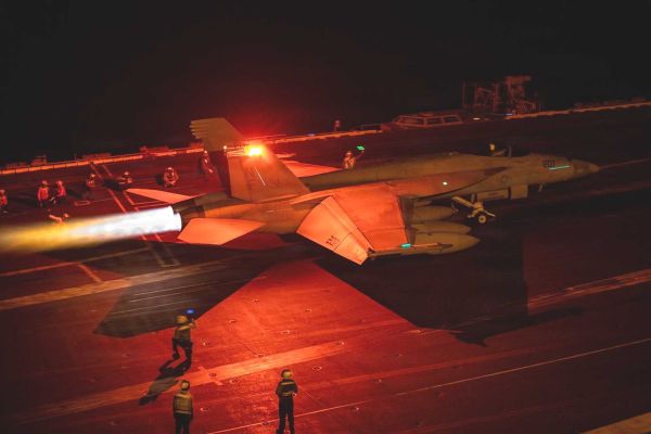 An F/A-18 Super Hornet prepares to launch from the flight deck of USS George Washington (CVN 73) while the aircraft carrier operates in Middle Eastern waters amid sustained U.S. naval activity linked to enforcement of the blockade against Iran.